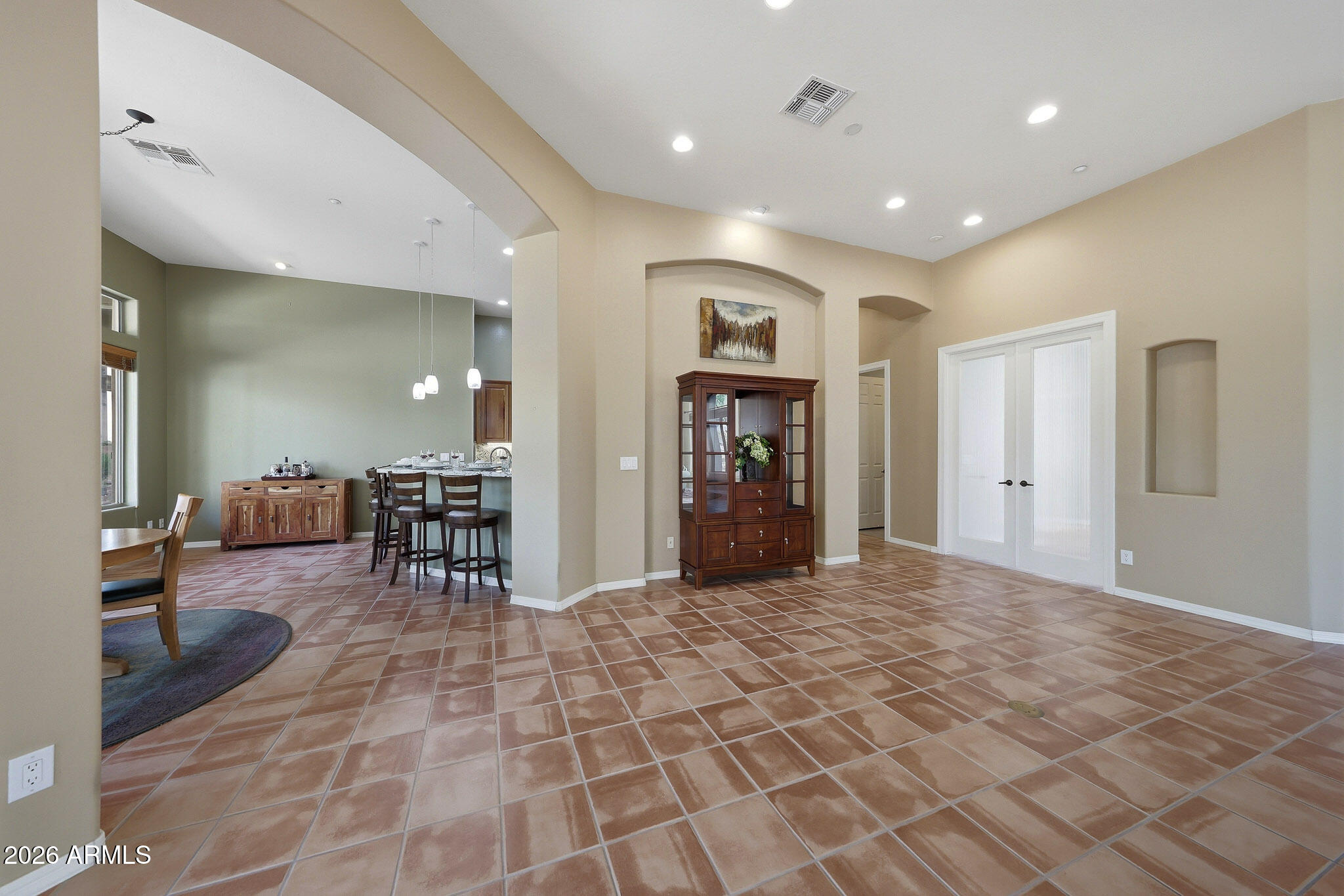 2129 West Legends Way Anthem, AZ 85086 - Photo 11 of 57 a view of a hallway with dining area and chandelier