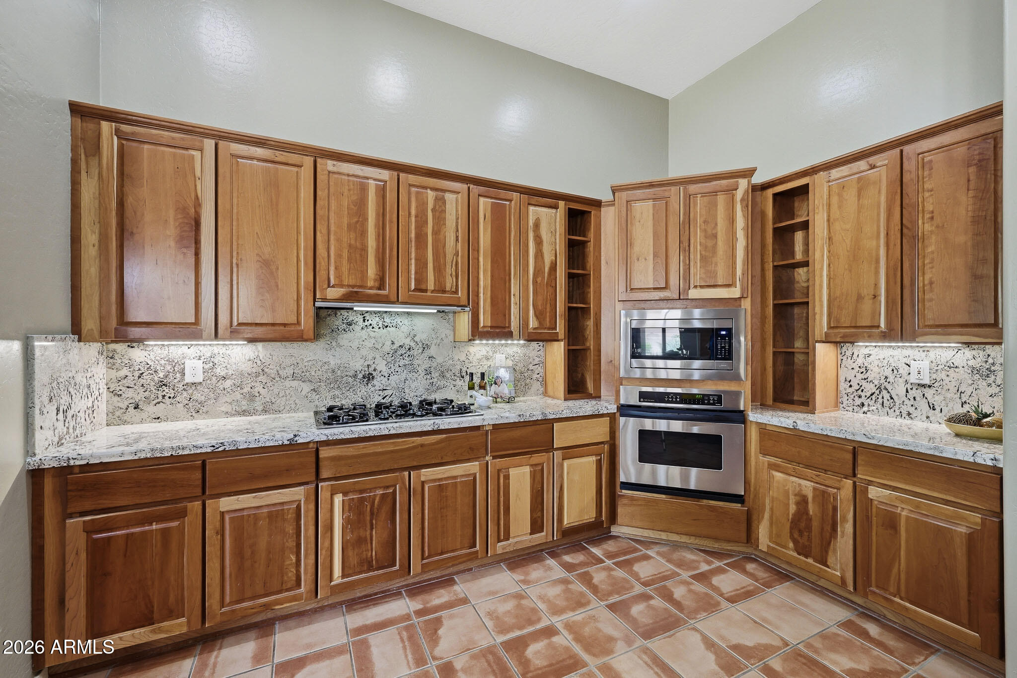 2129 West Legends Way Anthem, AZ 85086 - Photo 13 of 57 a kitchen with stainless steel appliances granite countertop a stove a sink dishwasher and a refrigerator