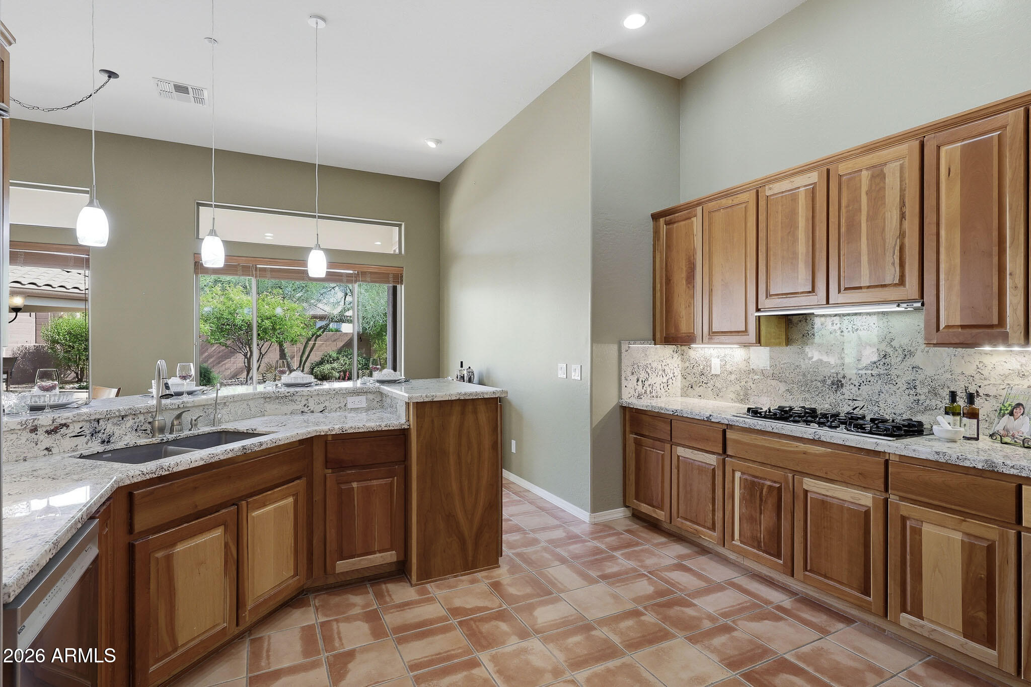 2129 West Legends Way Anthem, AZ 85086 - Photo 14 of 57 a kitchen with a sink stove and cabinets