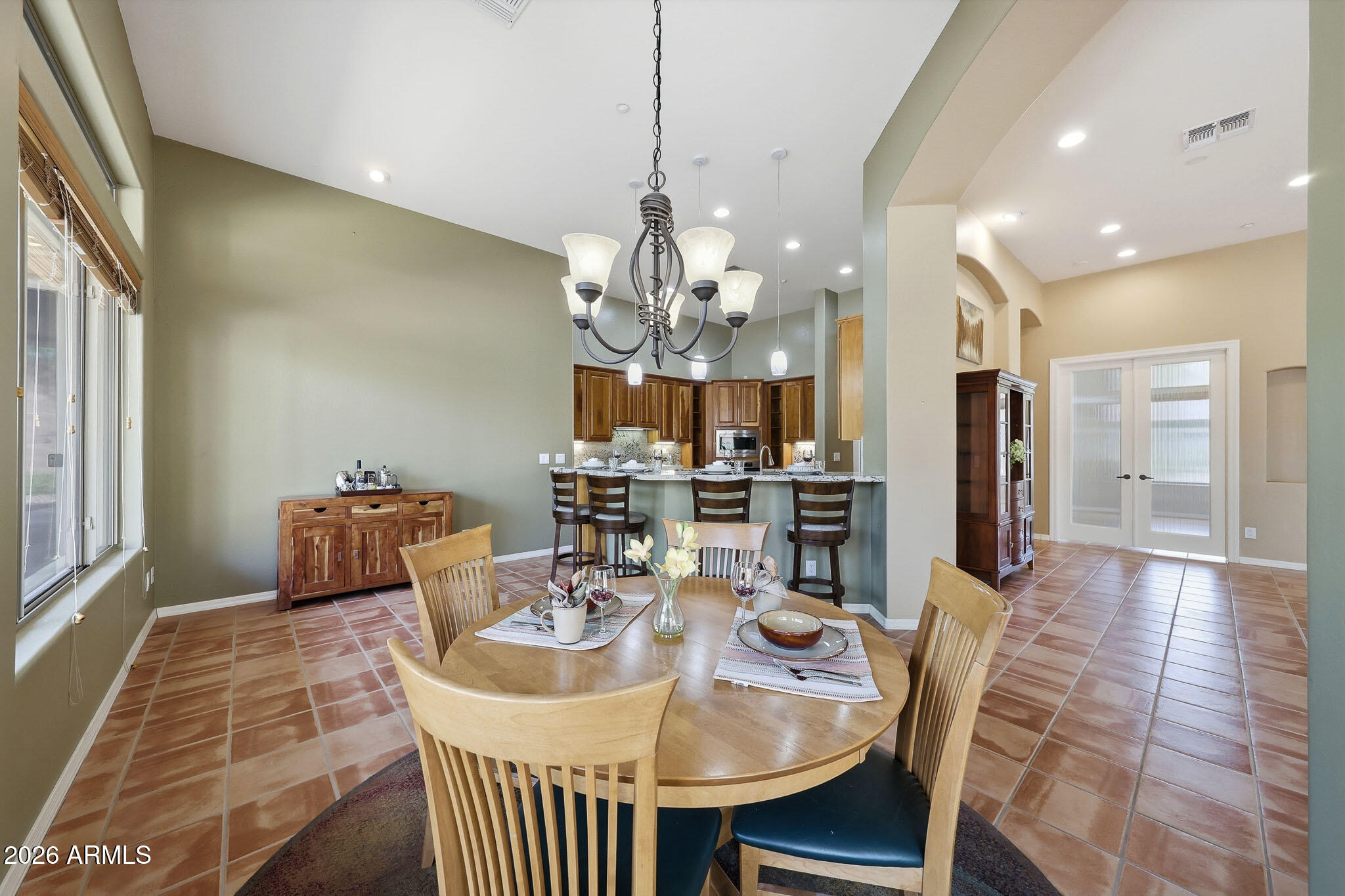2129 West Legends Way Anthem, AZ 85086 - Photo 18 of 57 a view of a dining room with furniture and chandelier