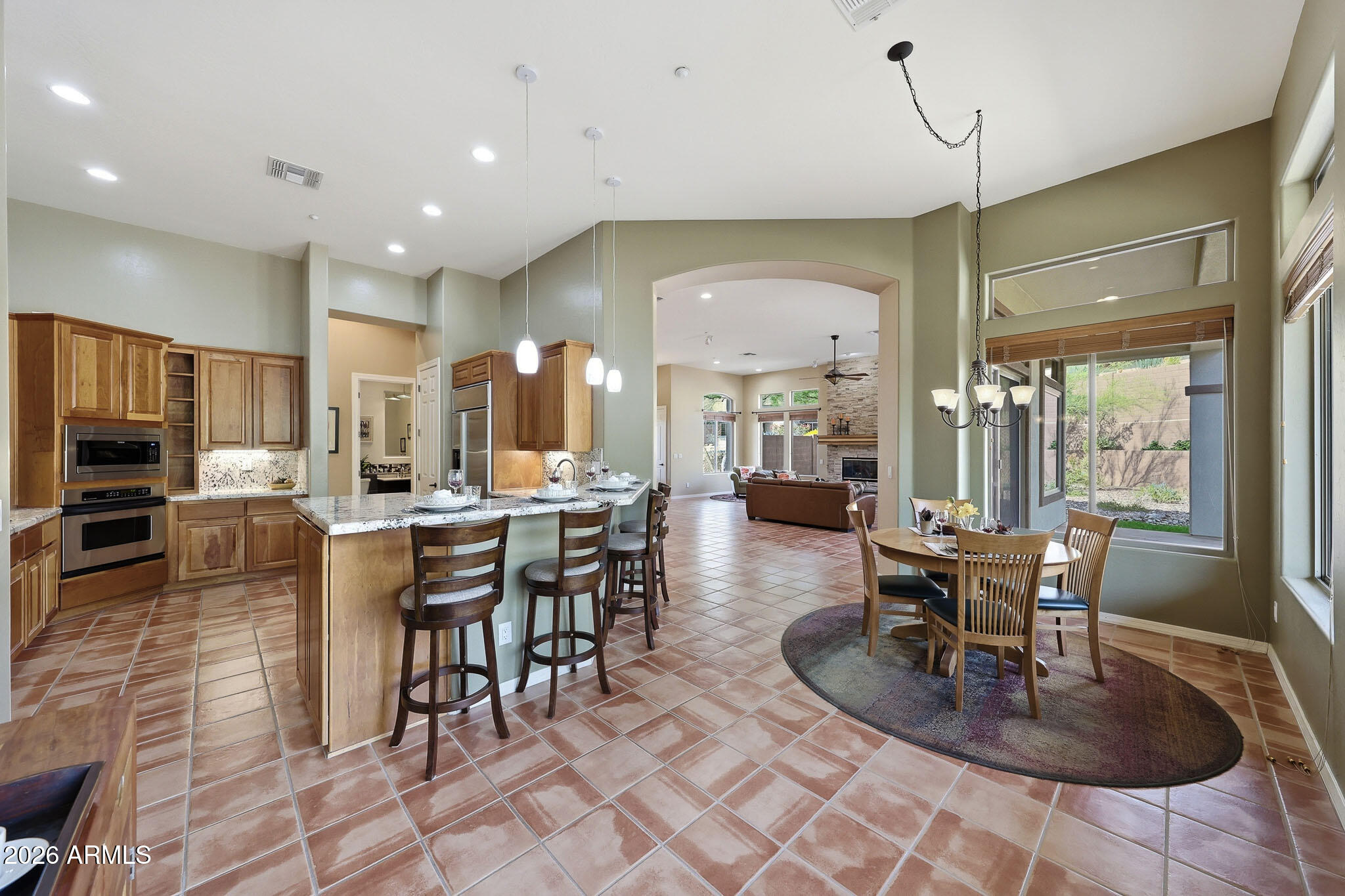 2129 West Legends Way Anthem, AZ 85086 - Photo 19 of 57 a dining room with furniture a large window and kitchen view