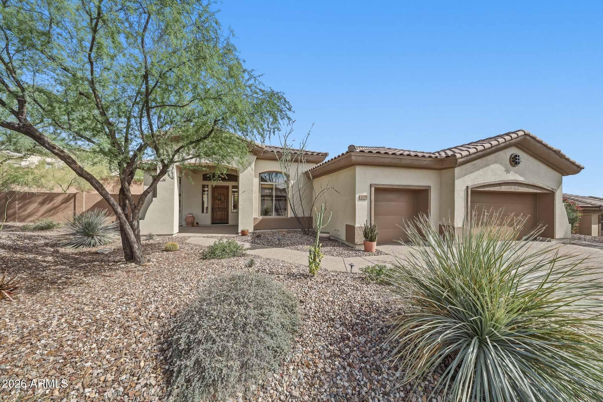 2129 West Legends Way Anthem, AZ 85086 - Photo 2 of 57 a view of a house with a tree in front