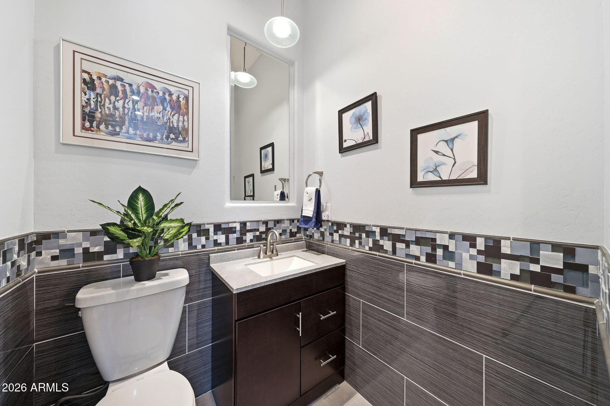 2129 West Legends Way Anthem, AZ 85086 - Photo 24 of 57 a bathroom with a toilet a sink and mirror