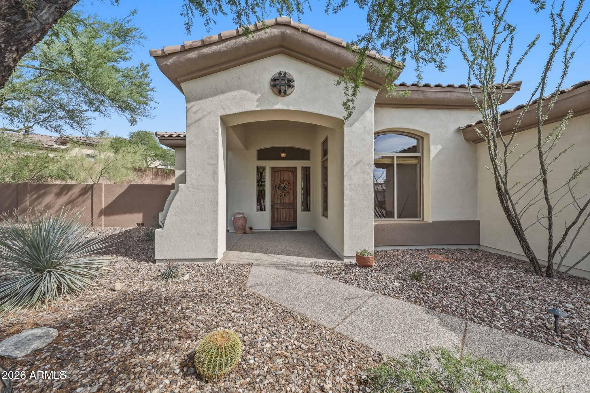 2129 West Legends Way Anthem, AZ 85086 - Photo 4 of 57 a front view of a house with garden