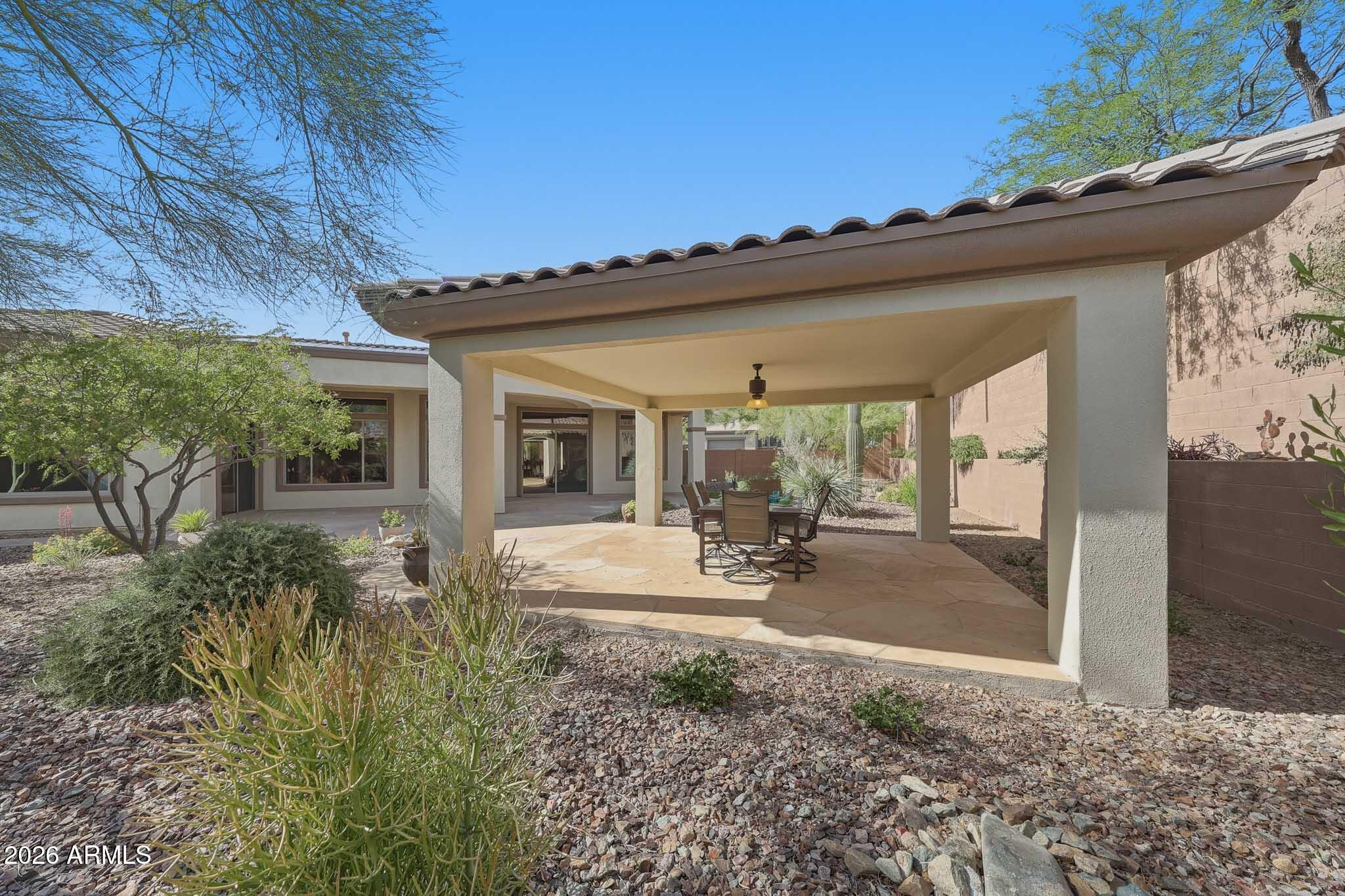 2129 West Legends Way Anthem, AZ 85086 - Photo 47 of 57 a view of a backyard with plants and outdoor seating