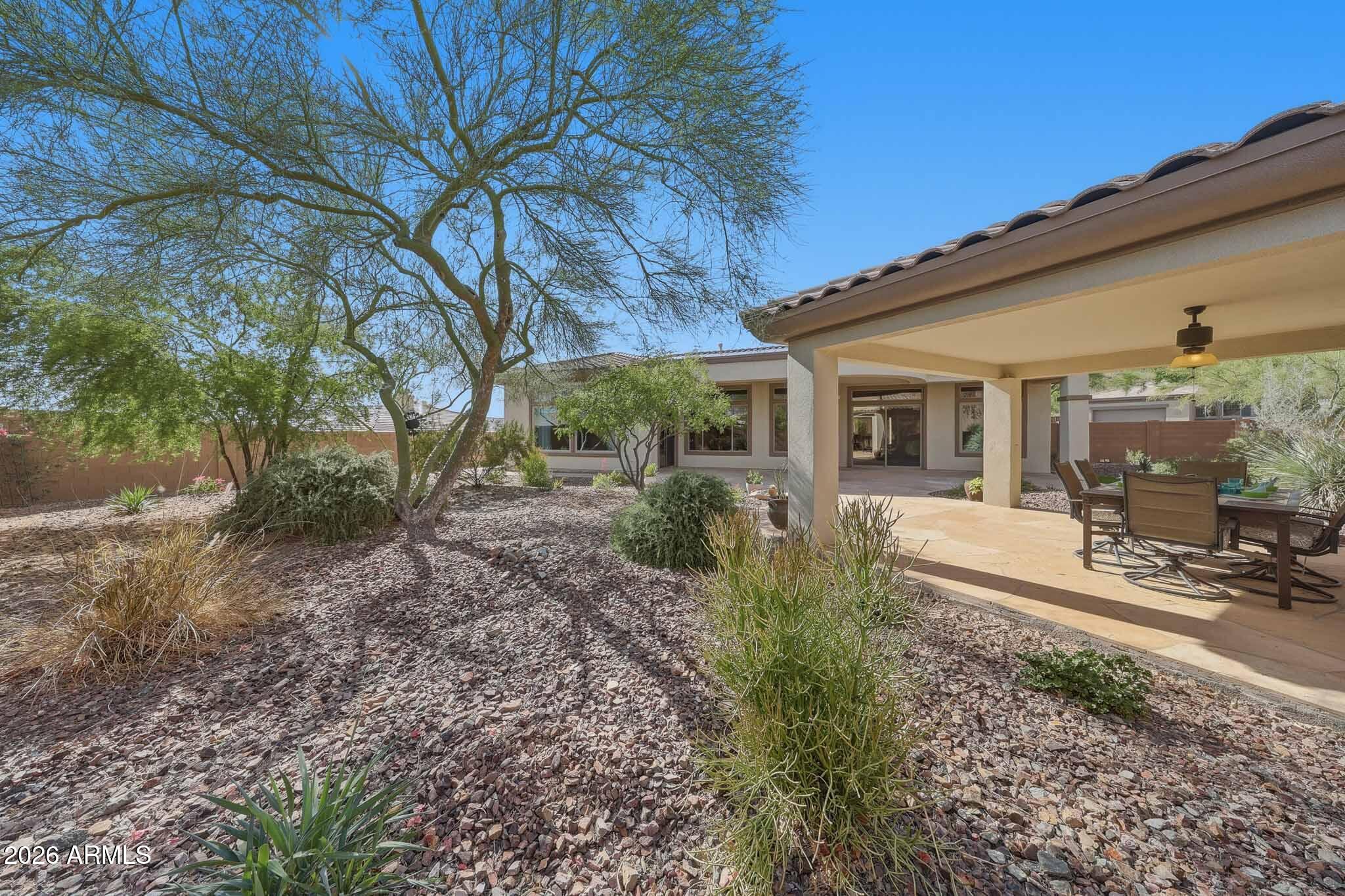 2129 West Legends Way Anthem, AZ 85086 - Photo 48 of 57 a view of a backyard with large trees and plants