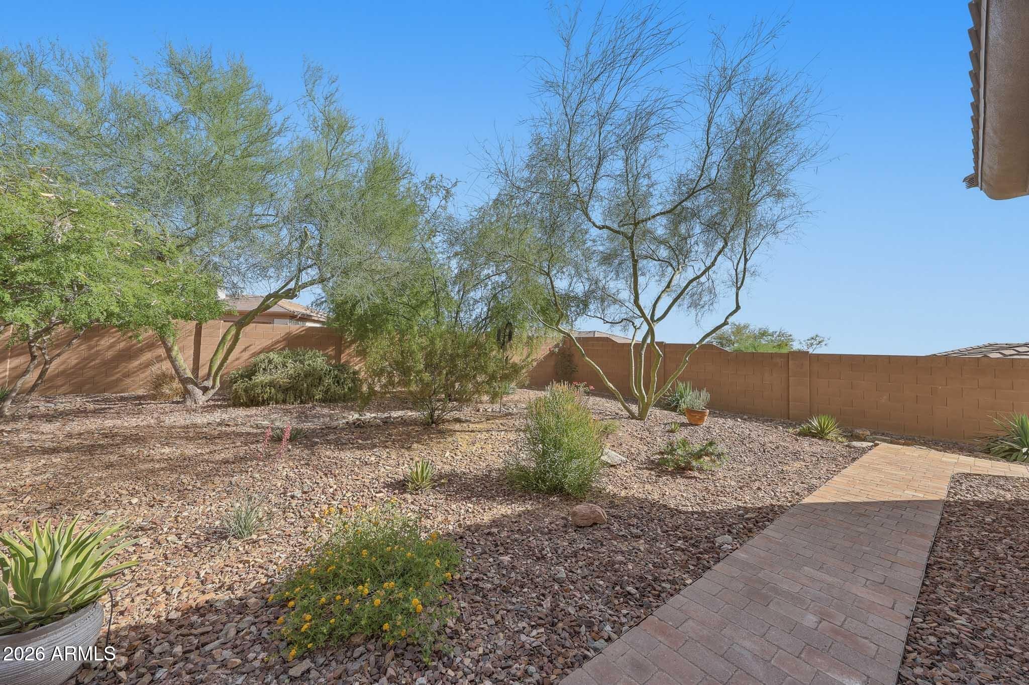 2129 West Legends Way Anthem, AZ 85086 - Photo 51 of 57 a backyard of a house with large trees
