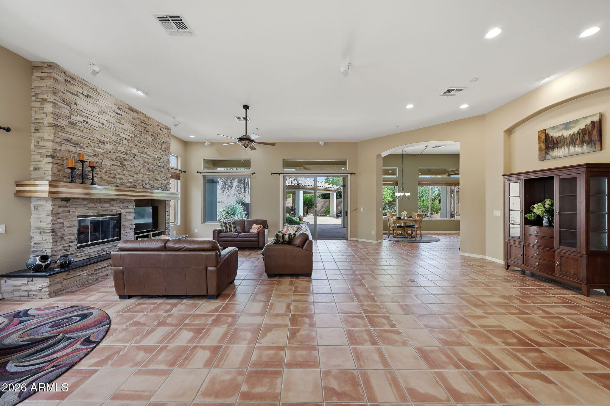 2129 West Legends Way Anthem, AZ 85086 - Photo 9 of 57 a living room with furniture and a fireplace