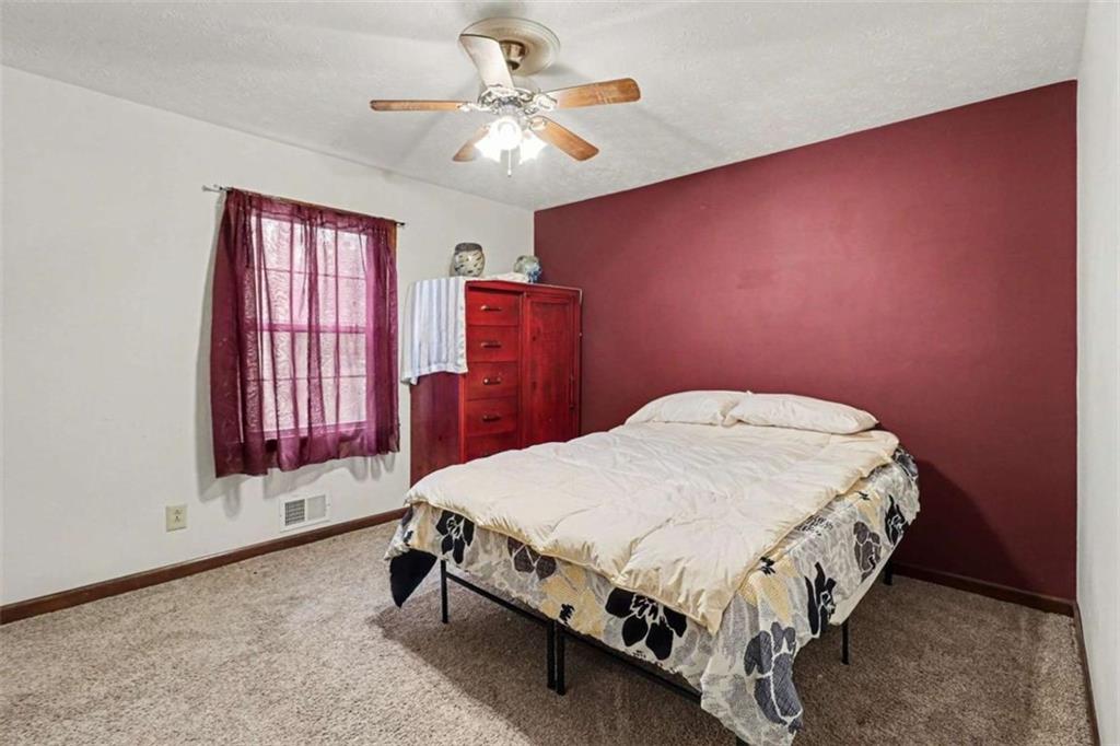 7495 Phillips Road Chattahoochee Hills, GA 30268 - Photo 12 of 26 a bed sitting in a spacious bedroom next to a window