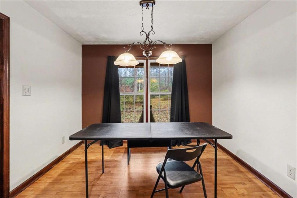 7495 Phillips Road Chattahoochee Hills, GA 30268 - Photo 8 of 26 a view of a dining room with furniture window and wooden floor
