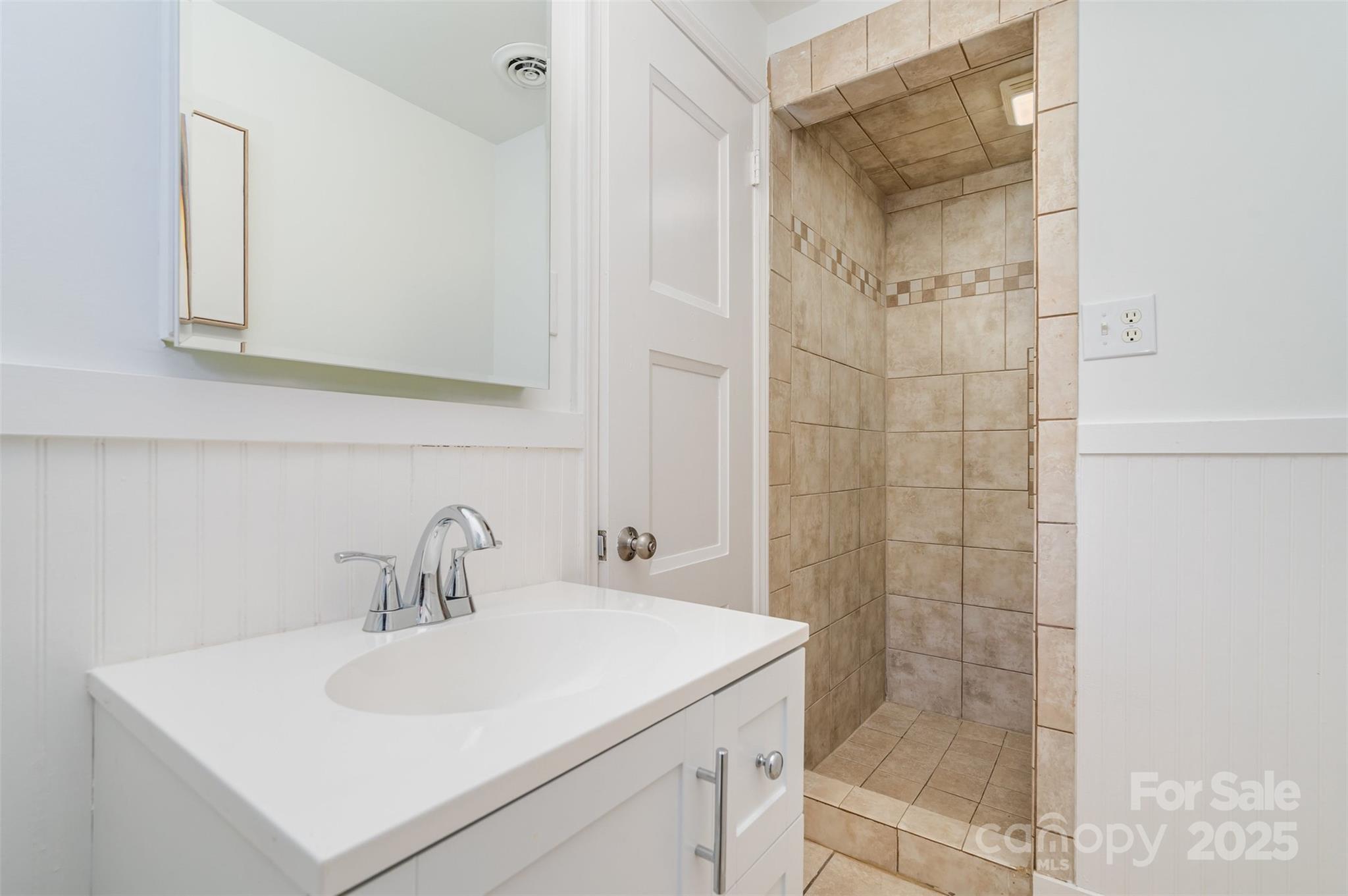 5411 Doncaster Drive Charlotte, NC 28211 - Photo 32 of 40 a bathroom with a sink a mirror and shower