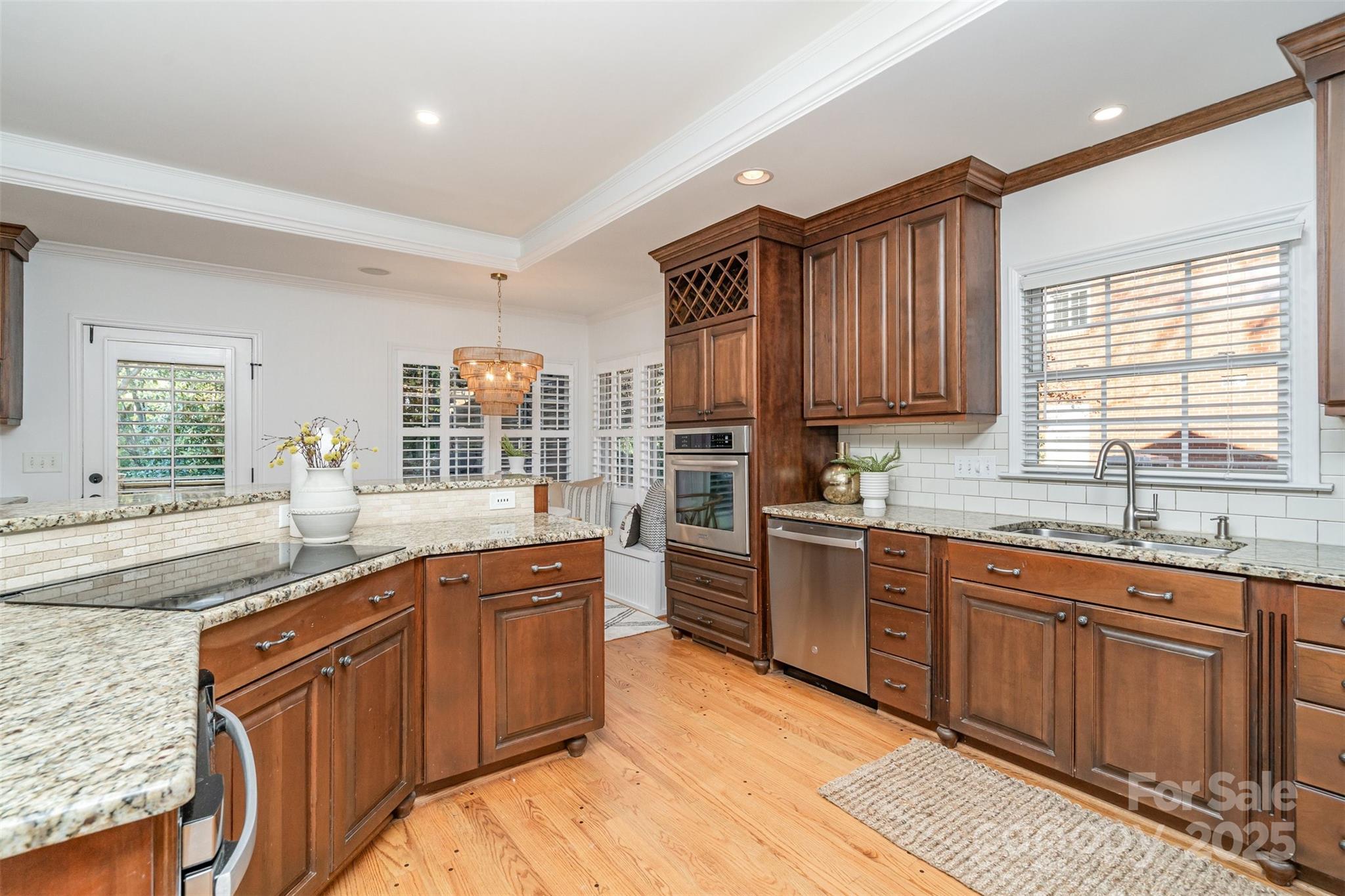 5411 Doncaster Drive Charlotte, NC 28211 - Photo 8 of 40 a kitchen with stainless steel appliances granite countertop wooden cabinets sink and window
