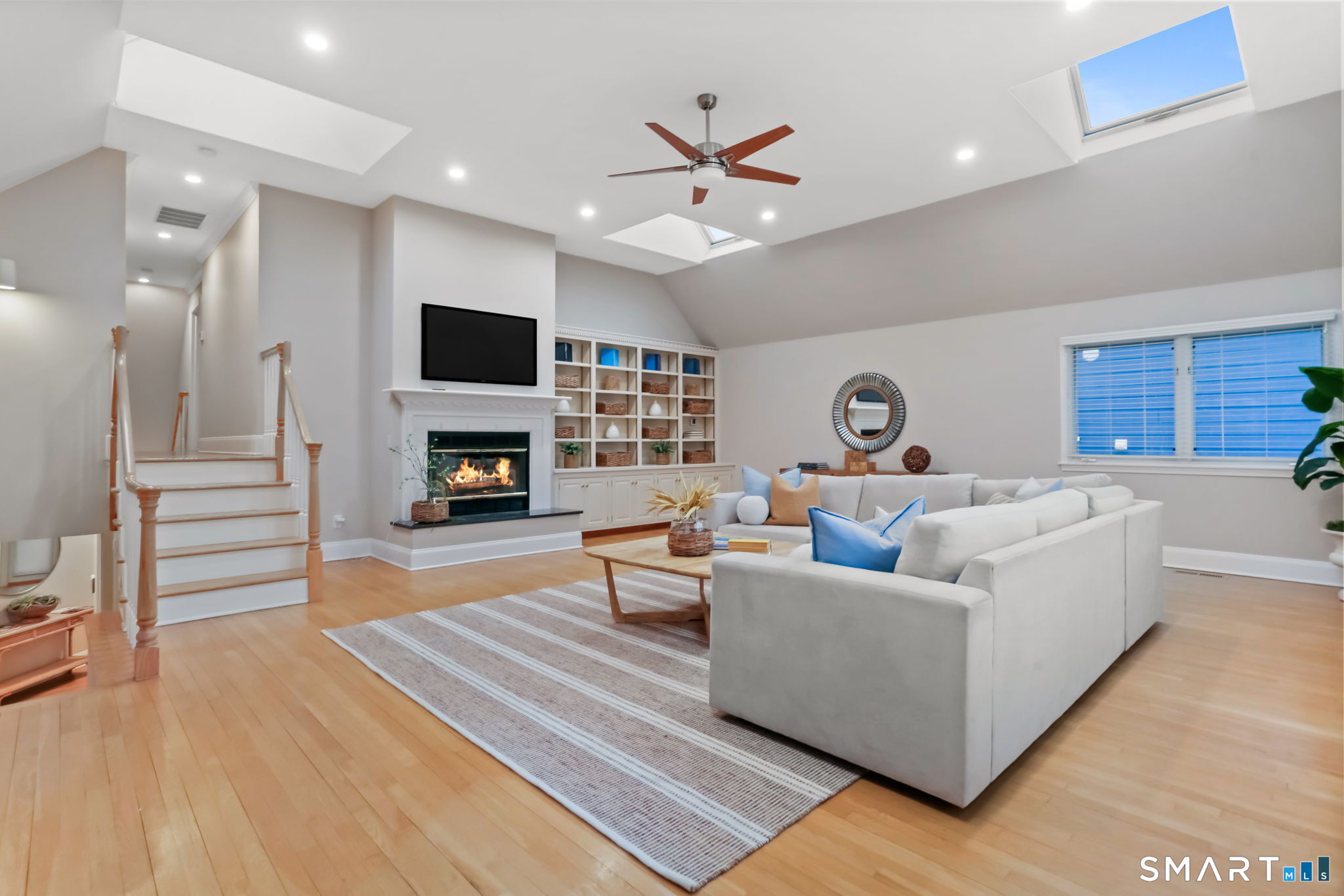 1149 Fairfield Beach Road Fairfield, CT 06824 - Photo 20 of 44 Mezzanine Great Room w/12 foot ceilings and wall of built ins provide a great palette for all of your artwork and family photos. Light the Fireplace on those cozy winter movie nights.