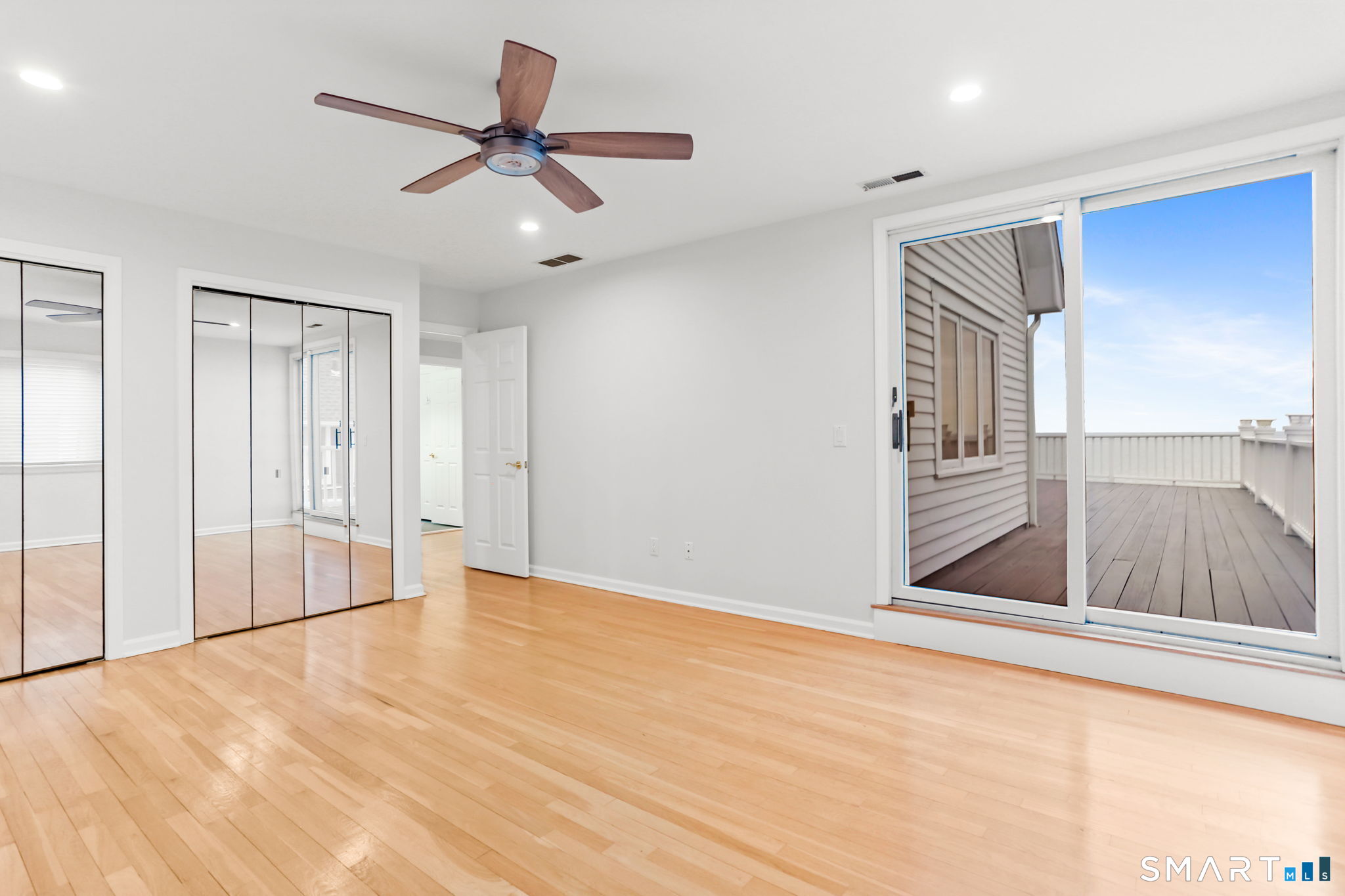 1149 Fairfield Beach Road Fairfield, CT 06824 - Photo 27 of 44 Waterfront bedrooms each open onto their own section of the wraparound deck, offering a private retreat for every space. Bedroom 2 shown here, so much space and a wall of closets