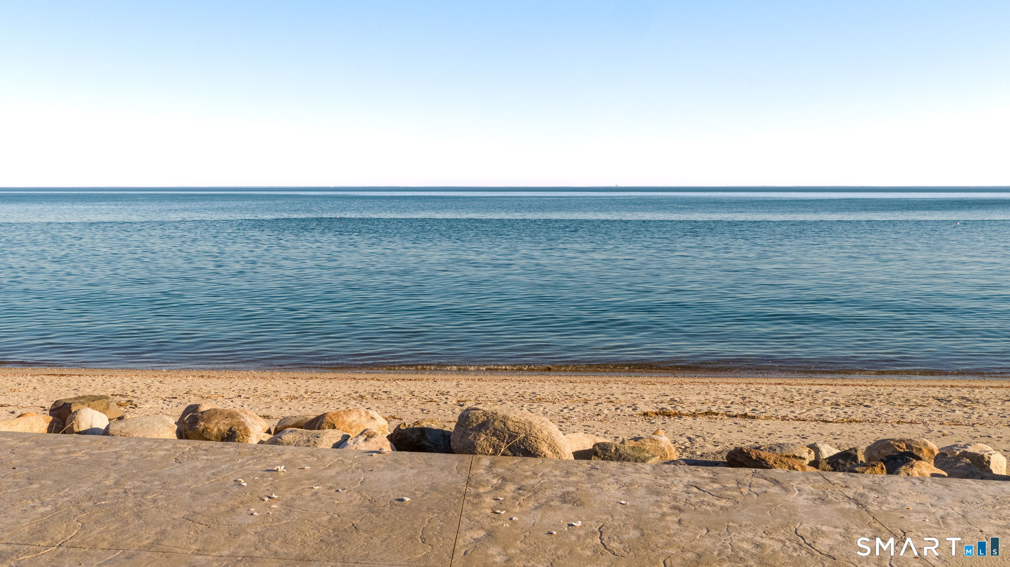 1149 Fairfield Beach Road Fairfield, CT 06824 - Photo 4 of 44 Large River Rocks line the expansive patio and create a nice view to the water