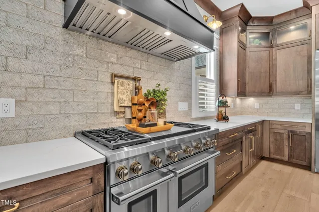 a kitchen with cabinets and stainless steel appliances