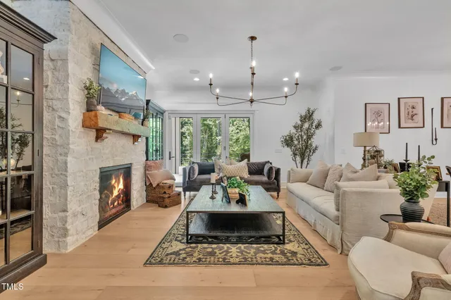 a living room with furniture potted plant and a large window