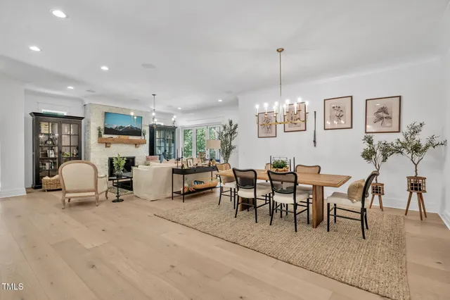 a view of a dining room with furniture and chandelier