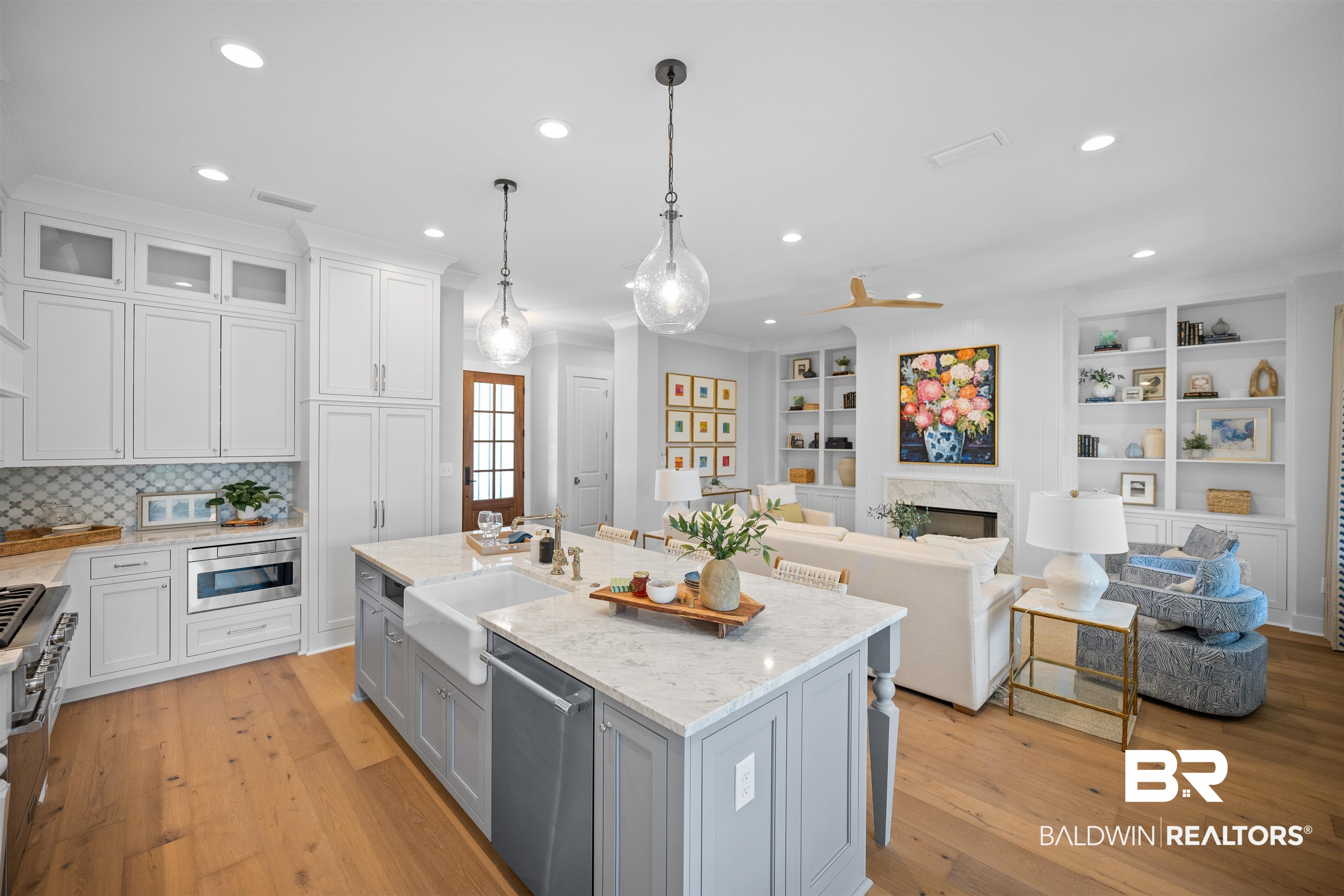 156 Hyacinth Street Fairhope, AL 36532 - Photo 61 of 61 Kitchen featuring white cabinets, light stone countertops, pendant lighting, open floor plan, and light wood-style floors