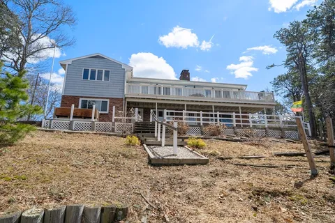 a view of a house with backyard space and balcony