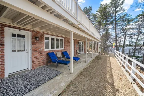 a view of a house with backyard and sitting area
