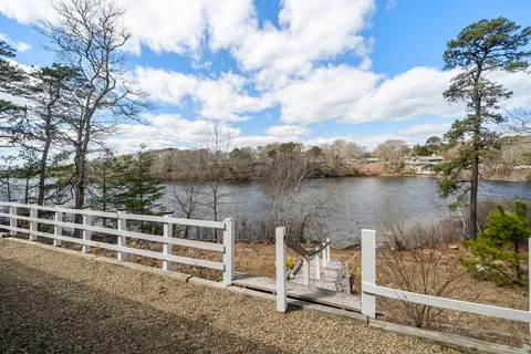 a view of a lake with houses in back