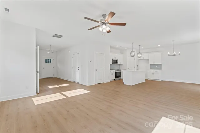 a kitchen with kitchen island granite countertop appliances cabinets and a counter top space