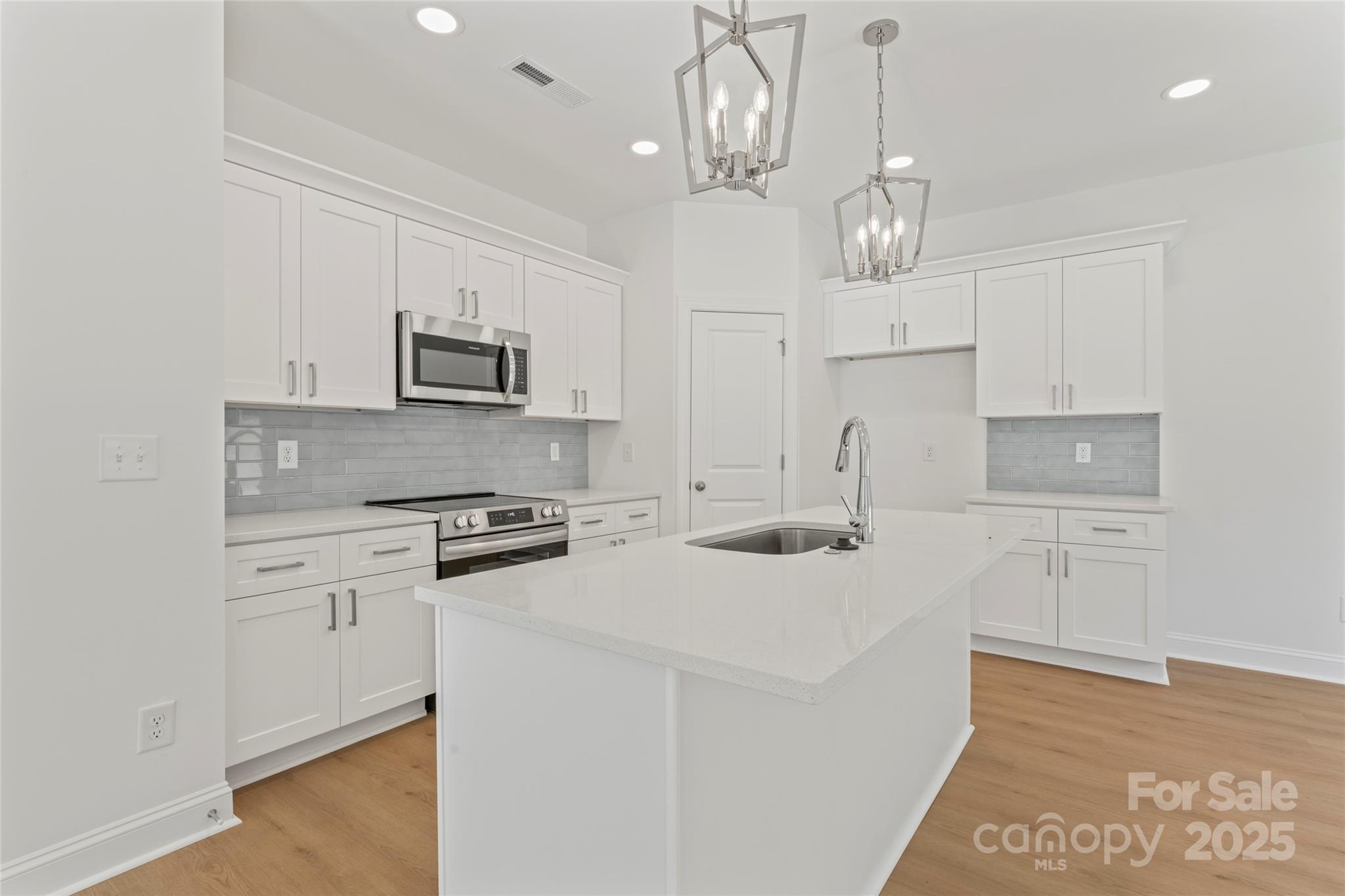 757 Mockingbird Road, Unit 4 Albemarle, NC 28001 - Photo 17 of 36 a kitchen with kitchen island granite countertop appliances cabinets and a counter top space