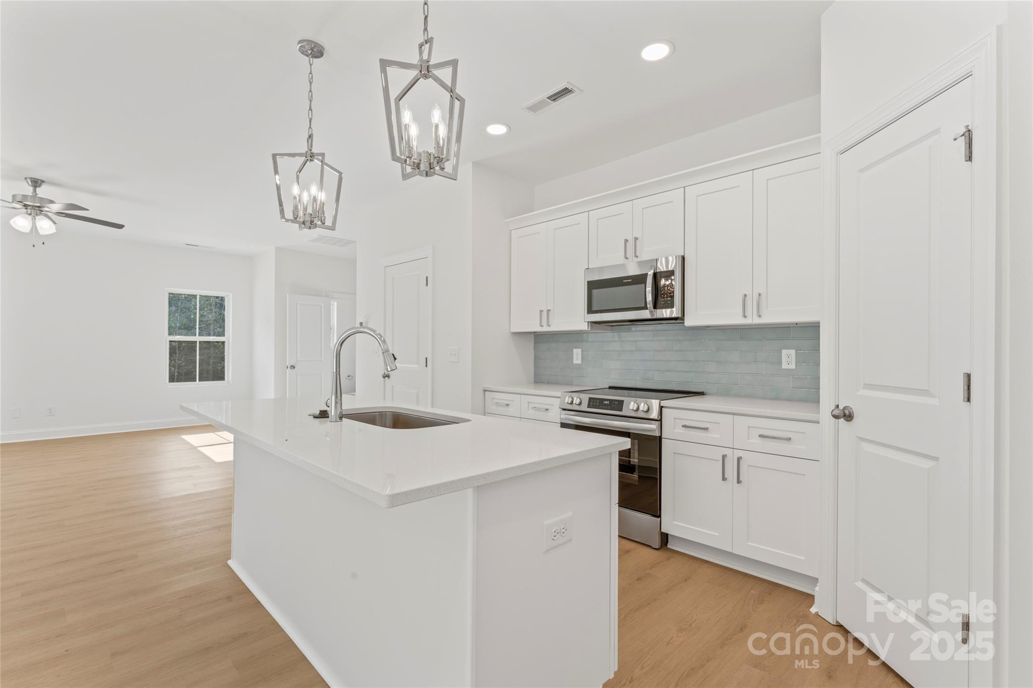 757 Mockingbird Road, Unit 4 Albemarle, NC 28001 - Photo 22 of 36 a kitchen with stainless steel appliances granite countertop a stove a sink and a refrigerator