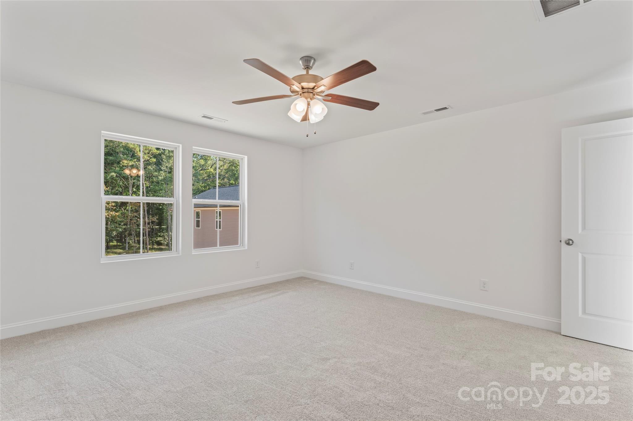 757 Mockingbird Road, Unit 4 Albemarle, NC 28001 - Photo 27 of 36 an empty room with a window and a fan