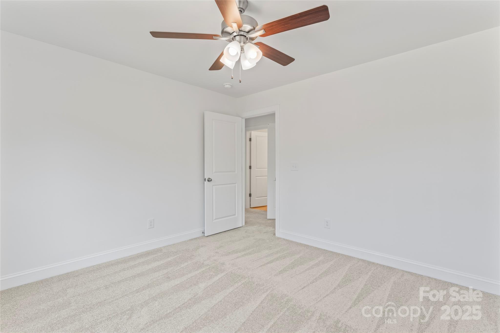 757 Mockingbird Road, Unit 4 Albemarle, NC 28001 - Photo 31 of 36 an empty room with a chandelier fan and windows