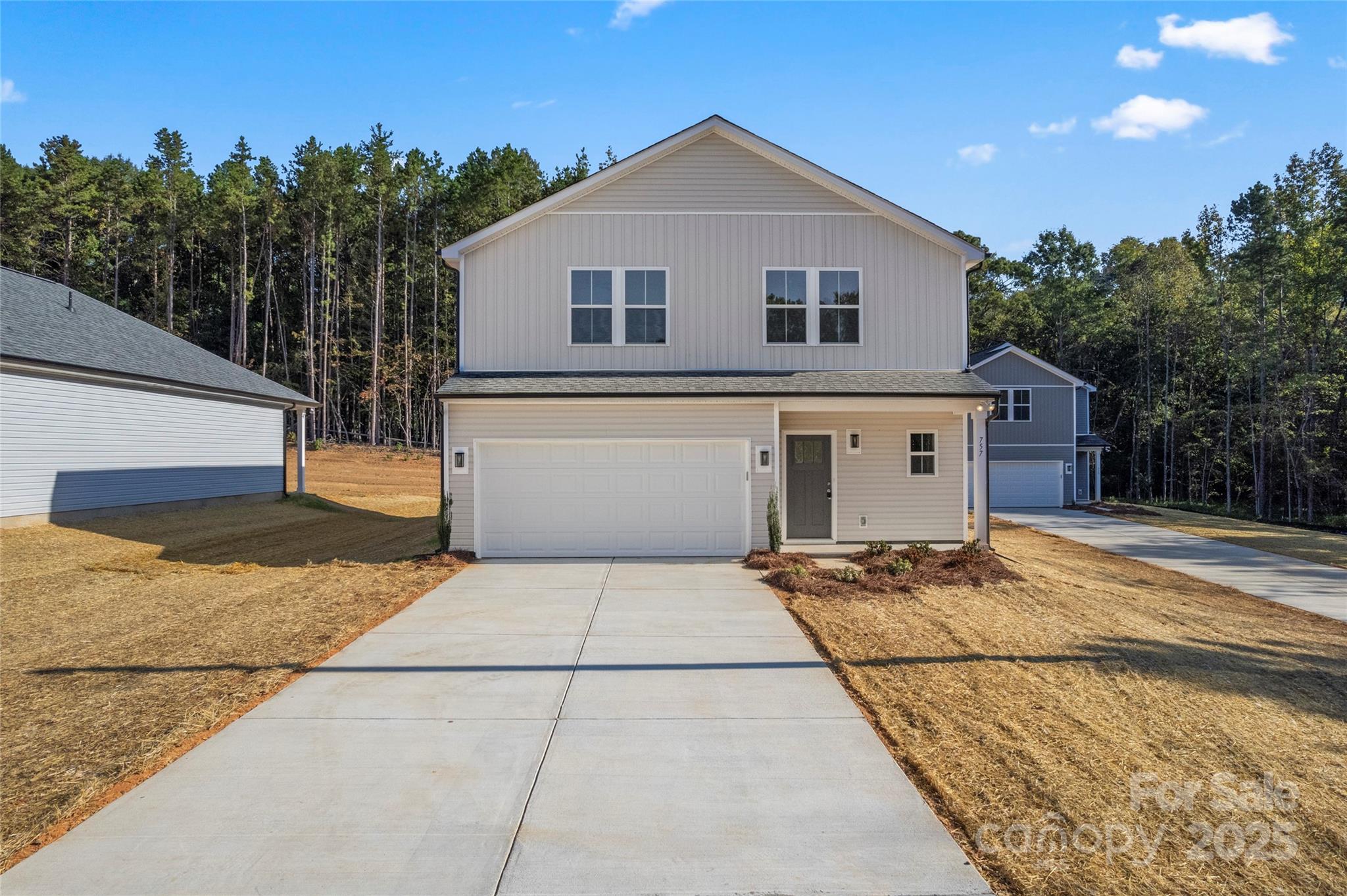 757 Mockingbird Road, Unit 4 Albemarle, NC 28001 - Photo 7 of 36 a front view of a house with a yard and garage