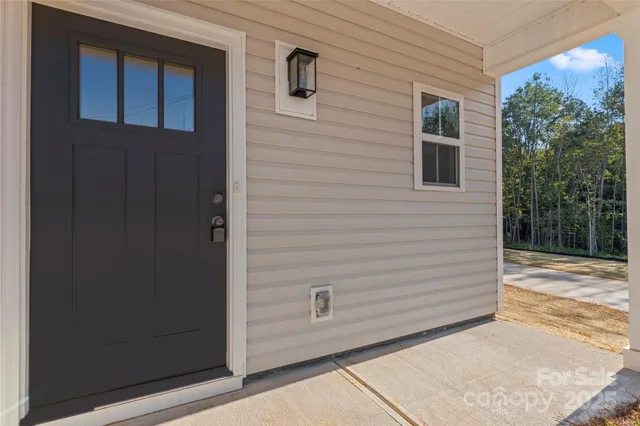 a view of an empty room with a kitchen