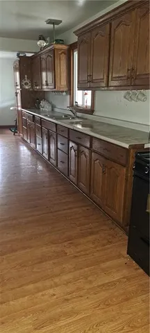 a kitchen with stainless steel appliances granite countertop a sink counter space and cabinets
