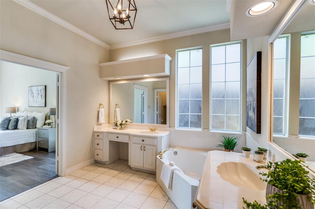 4015 Stonehollow Way Dallas, TX 75287 - Photo 16 of 26 a spacious en suite bathroom with a granite countertop tub and a large mirror