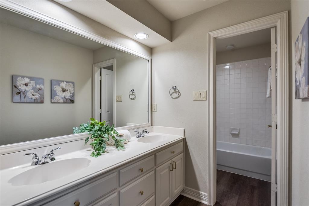 4015 Stonehollow Way Dallas, TX 75287 - Photo 17 of 26 a bathroom with a sink a potted plant and a mirror