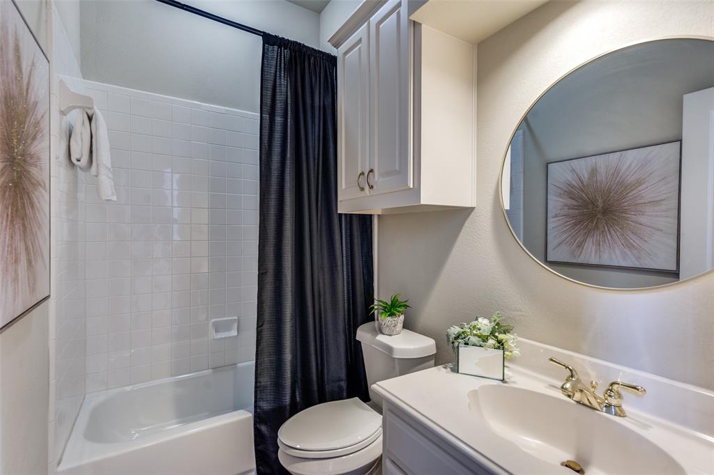 4015 Stonehollow Way Dallas, TX 75287 - Photo 6 of 26 a bathroom with a sink toilet and shower