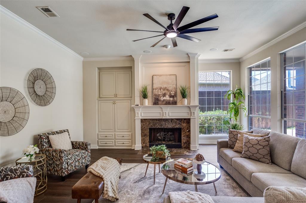 4015 Stonehollow Way Dallas, TX 75287 - Photo 8 of 26 a living room with furniture a fireplace and a large window