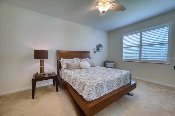 a bedroom with a bed and a lamp on table