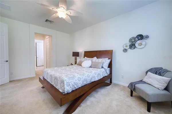 a bedroom with a bed and a couch