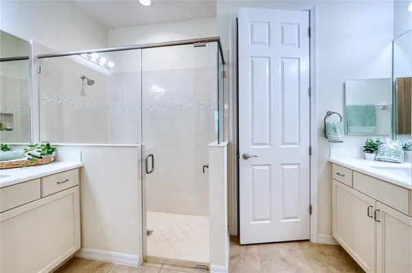a bathroom with a shower sink and mirror