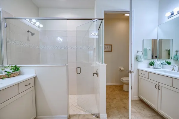 a bathroom with a shower sink and toilet