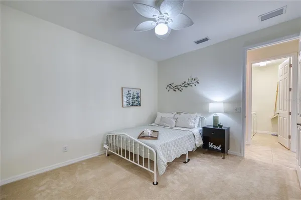 a spacious bedroom with a bed and a chandelier