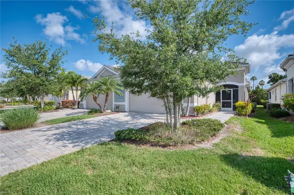 a view of a house with backyard and a tree