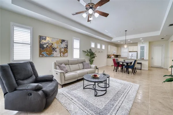 a living room with furniture and a chandelier