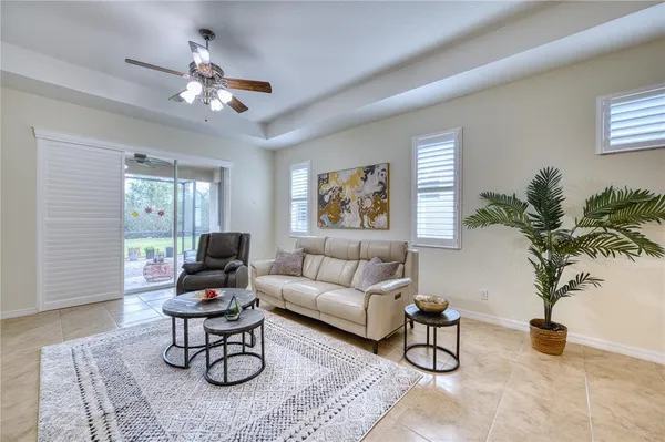a living room with furniture a chandelier and a window