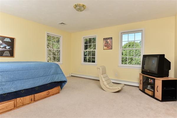 108 Deerfield Lane Hanover, MA 02339 - Photo 18 of 28 a bedroom with a bed and a flat screen tv