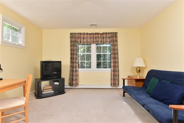 108 Deerfield Lane Hanover, MA 02339 - Photo 19 of 28 a living room with furniture and a flat screen tv