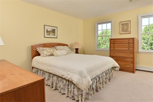 108 Deerfield Lane Hanover, MA 02339 - Photo 20 of 28 a bedroom with a bed and a window