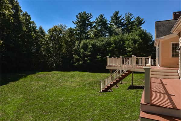 108 Deerfield Lane Hanover, MA 02339 - Photo 27 of 28 a view of a deck with a yard